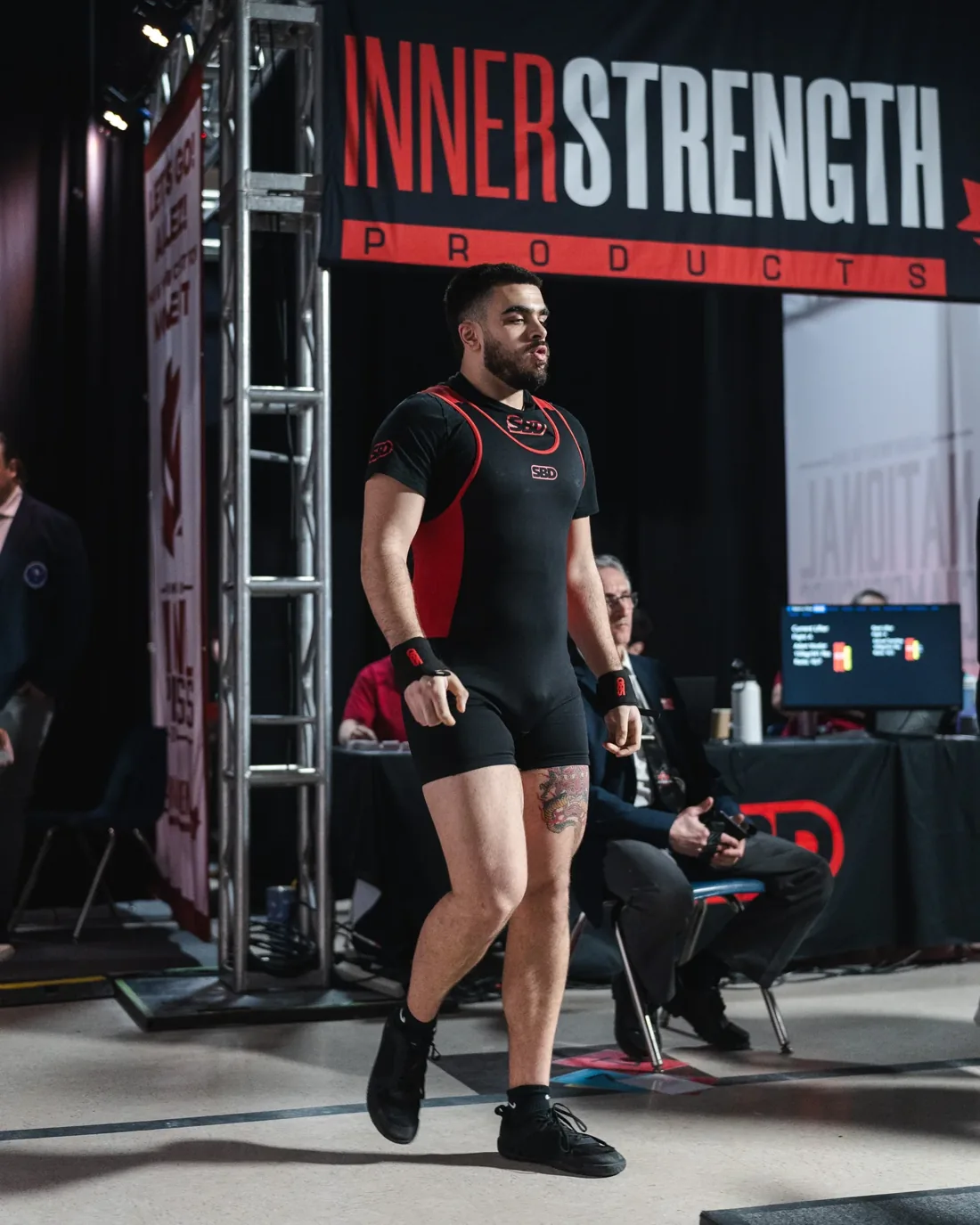 Adam Voutier walking out on the powerlifting platform
